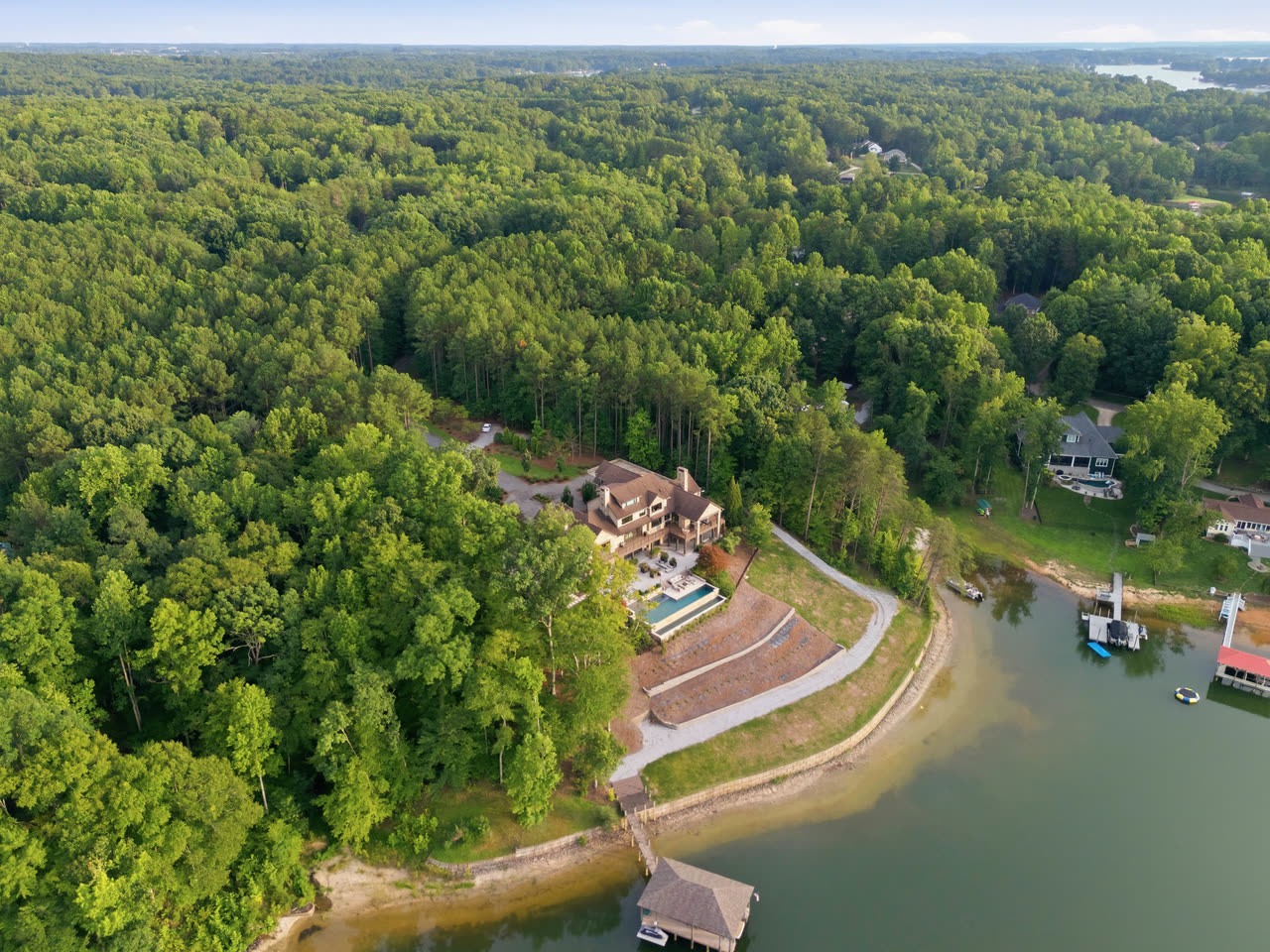 Aerial view of the estate on its wooded point, with Lake Norman beyond.