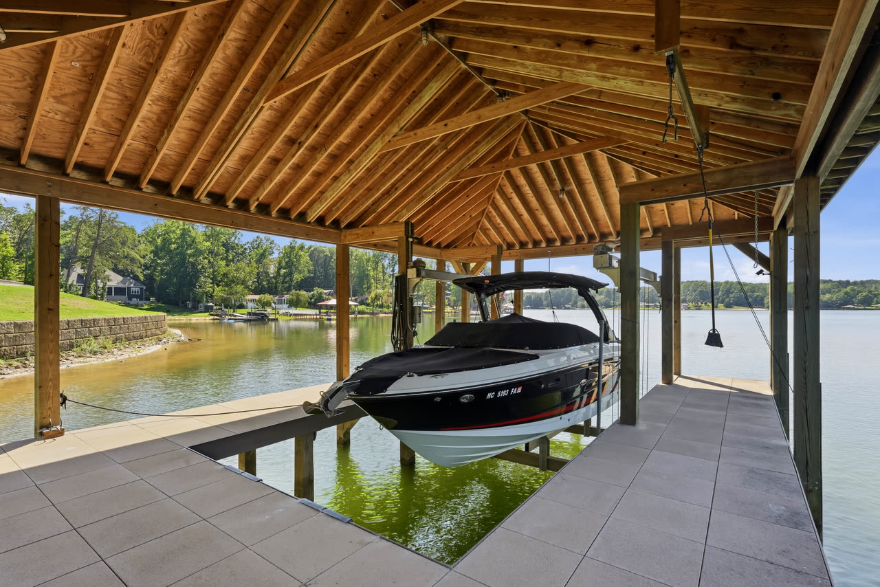 Inside the boat house, a covered slip and the lake beyond.