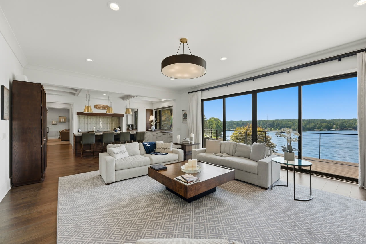 The great room looking straight out at Lake Norman through a wall of glass.