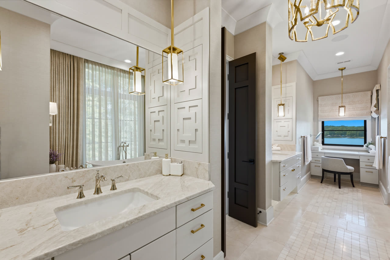 The primary bathroom vanity, with the tub and the window beyond.