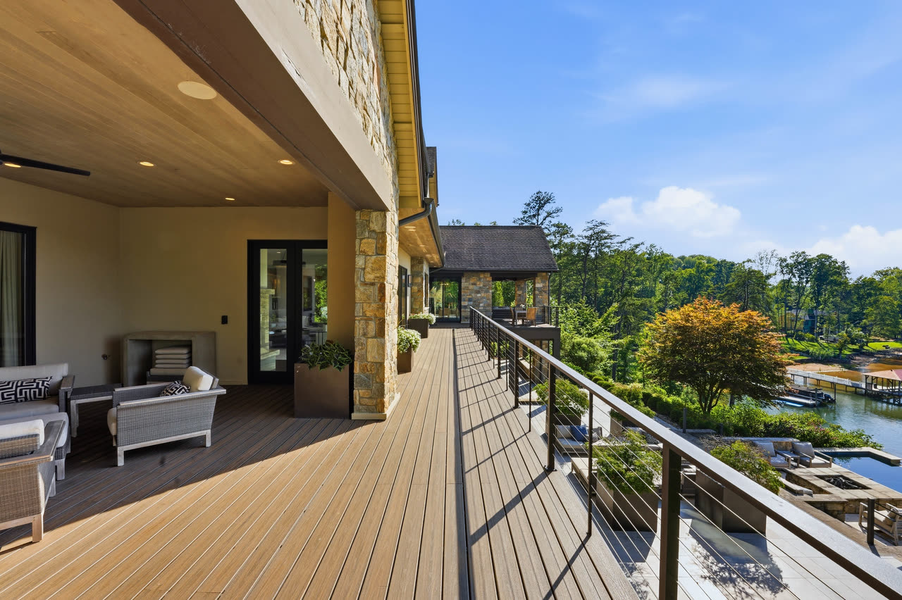 The deck running along the back of the house above the pool.