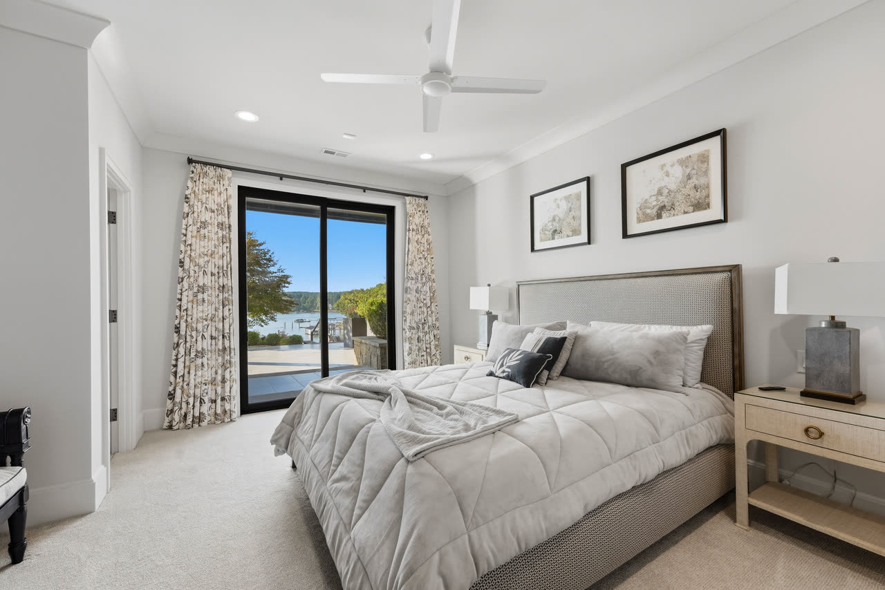 A guest bedroom in grey with sliding doors onto the terrace.