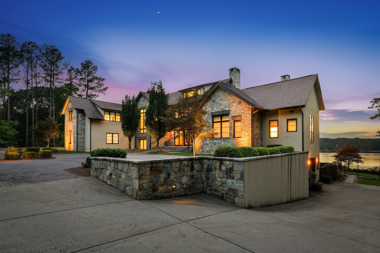 The motor court at twilight, the house lit along its length.